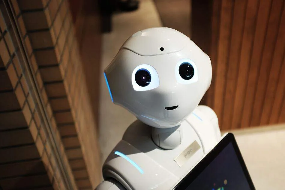 A friendly robot looking at the camera. Will AI Steal Your Jobs?